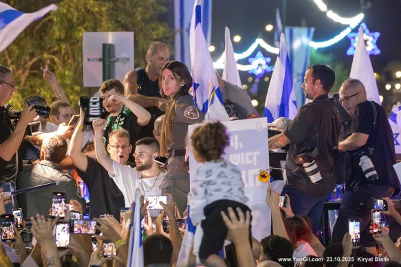 המונים הגיעו לחגוג את שובו של מתן אנגרסט (בחולצה לבנה, מניף יד) לביתו בקריית ביאליק לאחר שיחרורו ממחילות החמאס בעזה 23.10.2025